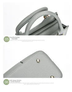 Détail des poignées en cuir gris et des clous de protection en métal sur le sac