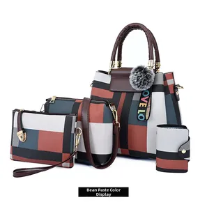 Detail of four-piece fashion handbag set with geometric pattern and pompom charm