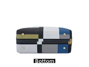 Detailed bottom view of geometric tote bag with textured leather and protective metal feet