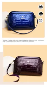 Macro detail of glossy crocodile texture and gold metal logo on elegant shoulder bags