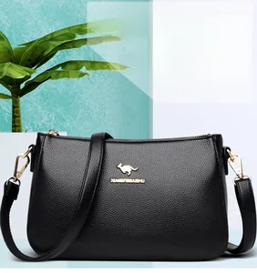 Close-up of black crossbody bag with pebble grain leather and golden kangaroo logo detail
