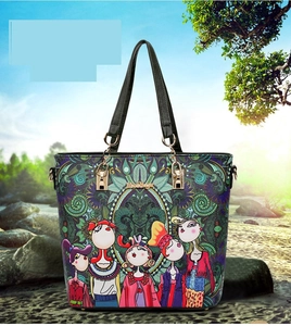 Detail of bohemian floral print tote bag with cartoon figures and golden hardware