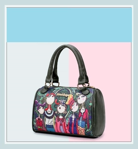 Close-up of Boston style handbag featuring colorful cartoon illustration and gold hardware