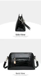 Close-up of black crocodile pattern patent leather bag with gold kangaroo charm