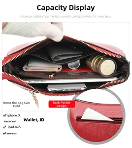 Internal view of red leather crossbody bag with three compartments and zip pocket