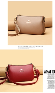 Detail of soft leather crossbody bag with lychee texture and golden kangaroo hardware