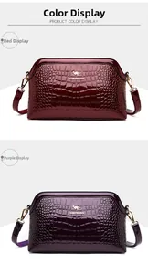Detail of red and purple crocodile-patterned patent leather bags with golden hardware