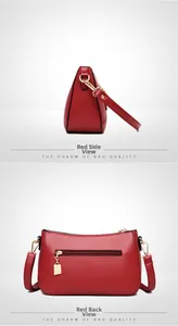 Detail view of red lychee grain leather handbag with gold zippers and kangaroo charm