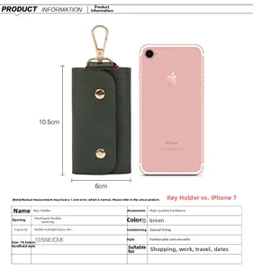 Detailed view of the dark green leather key pouch with gold hooks and size comparison