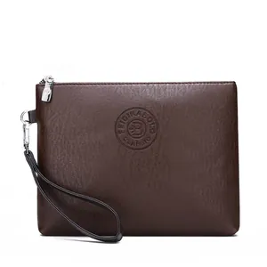 Detail view of dark brown pebbled leather texture with embossed circular brand logo