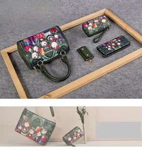 Detail view of green printed handbag set featuring cartoon folk patterns and accessories