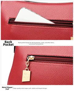 Detailed macro view of the back zipper pocket and golden hardware on the red leather bag