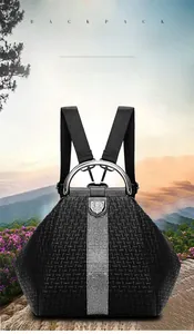 Black embossed backpack detail showing metal ring handle and rhinestone accents