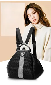 Detail of black woven leather backpack featuring crystal rhinestones and metal handle