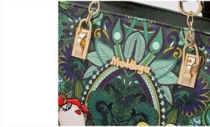 Close-up of vibrant mandala print on leather handbag with gold metal hardware and logo
