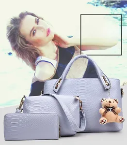 Detailed view of purple 3-piece bag set with crocodile texture and cute bear charm