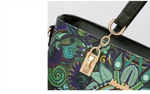 Close-up of vintage floral pattern on PU leather with golden hardware and logo detail