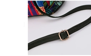 Detail of green faux leather strap with golden adjustable buckle on floral tote bag