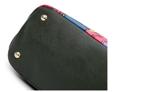 Close-up of bag bottom with protective gold studs and forest print details
