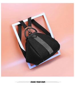 Close-up of black woven leather backpack with rhinestone vertical strips and metal handle