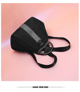 Detail of black woven texture and metallic silver stripe on a stylish women backpack