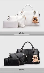 Close-up of three-piece handbag set in snake embossed leather with cute bear charms