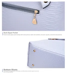 Detail of lavender snake embossed leather bag with gold zip and protective metal feet
