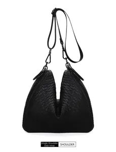 Side view of black woven leather shoulder bag with V-shaped opening and metallic hook