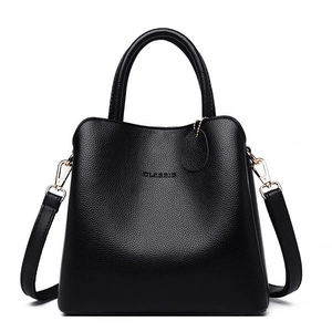 Black pebbled leather handbag with double handles and adjustable shoulder strap