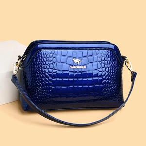 Navy blue patent leather crossbody bag with crocodile texture and gold kangaroo logo