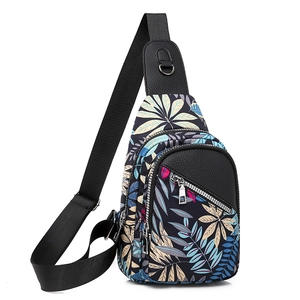 Detail view of the tropical leaf print fabric and litchi grain leather texture on the bag