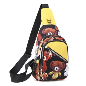 Detail view of cartoon bear print on Oxford fabric chest bag with yellow leather accents