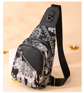 Detail of black oxford chest bag with white elephant and mandala floral pattern prints