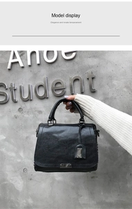 Gros plan d'un sac à main rétro noir avec texture fine et plaque métallique
