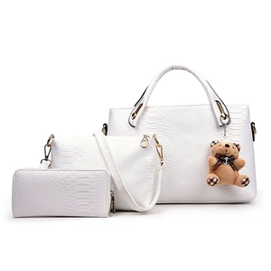 Three-piece white faux snakeskin handbag set including tote, crossbody bag, and wallet