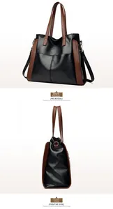Détail du grand sac cabas en similicuir noir avec bordure marron et boucle en métal latéral