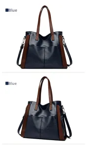 Détail d'un grand sac cabas bleu marine avec anses brunes et bandoulière réglable