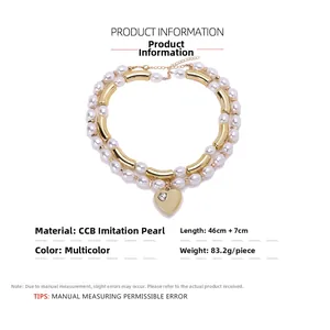 Detail view of double-layer faux pearl necklace with gold heart pendant and tube accents