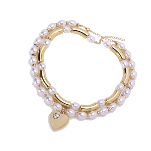 Double-layered pearl necklace with golden heart pendant and sparkling zircon stone