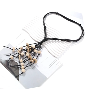 Ethnic multilayer necklace with black wax ropes and natural wooden bead tassel charms