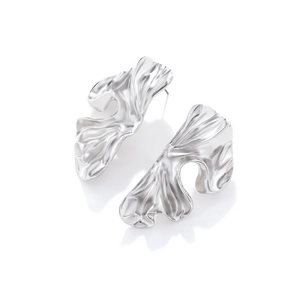 Irregular geometric silver earrings with vintage textured surface on white background