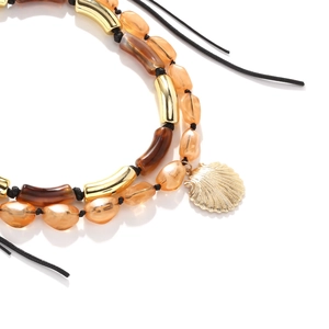 Layered resin bead necklace with gold shell pendant in bohemian vacation style
