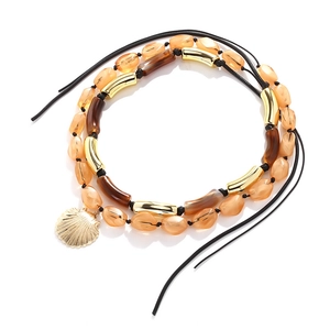 Double-layered beaded necklace featuring amber resin beads and a golden shell pendant