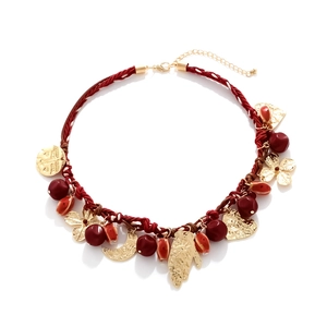 Bohemian red woven rope necklace with gold-toned charms including hand, moon and heart icons