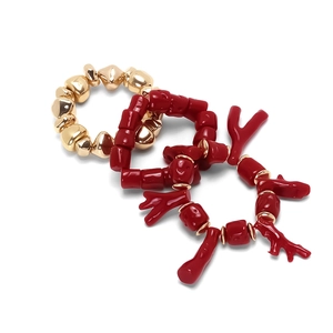 Three-piece stackable handmade bracelet set with red resin coral beads and gold metal accents