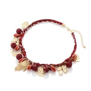 Bohemian woven red rope necklace with gold Hamsa hand, heart, and crescent moon charms