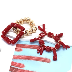 Three-piece stackable handmade bracelet set with red resin coral and gold irregular beads