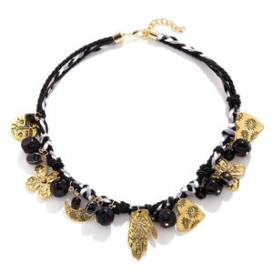 Bohemian woven rope necklace with gold palm, moon and heart pendants on white background