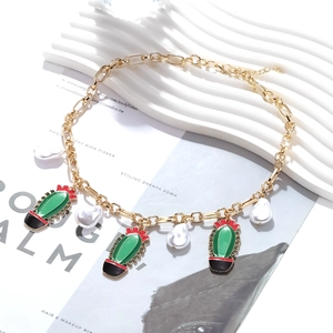 Exaggerated golden chain necklace with colorful enamel cactus charms and baroque pearls