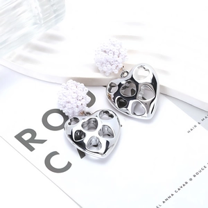 Fashionable hollow silver heart earrings with white beaded sphere accent for women
